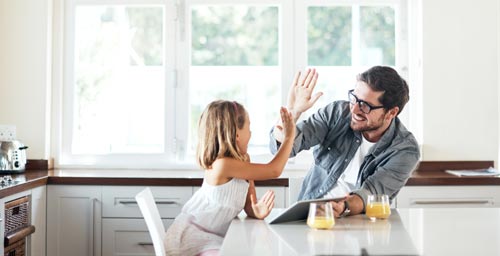 Father and daughter celebrating their new home loan